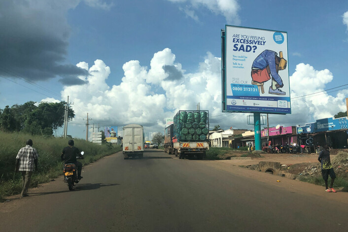 Street in Uganda with street commercial for the Helpline